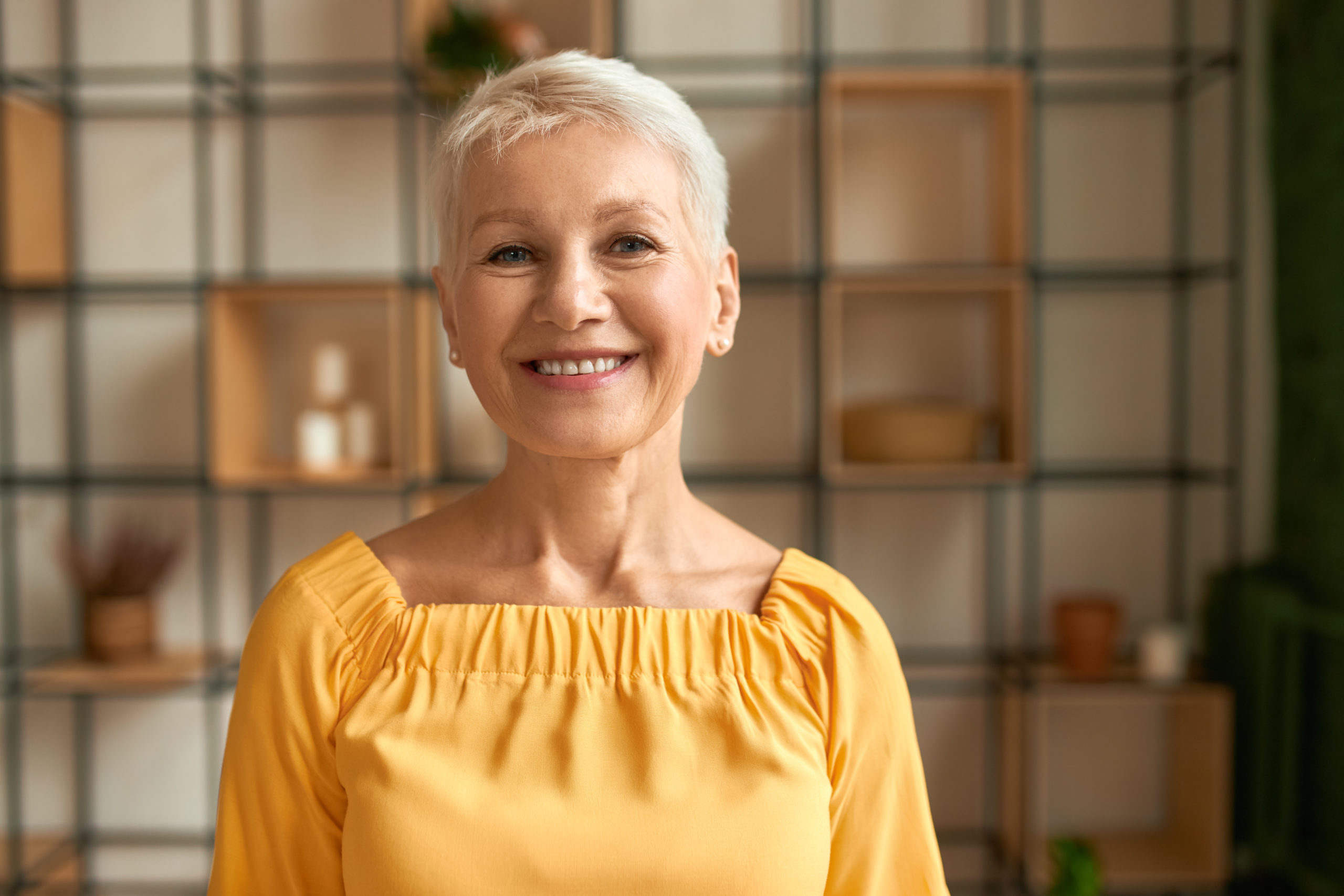 Portrait of joyful stylish middle aged woman with short ...