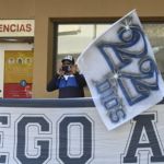 A supporter of Argentine former football star and coach of Gimnasia y Esgrima La Plata Diego Maradona, remains outside the Ipensa clinic where Maradona has been admitted, in La Plata, Buenos Aires province, on November 3, 2020. - Argentine football great Diego Maradona was admitted to hospital Monday for medical checks, his personal doctor announced. (Photo by JUAN MABROMATA / AFP)